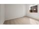 Clean bedroom featuring neutral carpet, white walls, a window and a door at 22500 E Orchard Ln, Queen Creek, AZ 85142