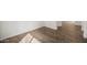 Close-up of wood-look tile flooring with white baseboards and plenty of natural light at 22500 E Orchard Ln, Queen Creek, AZ 85142