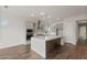 Open kitchen featuring an island with a white countertop, gray cabinets, and stainless appliances at 22500 E Orchard Ln, Queen Creek, AZ 85142