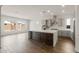 Open concept kitchen featuring a large island, modern appliances, ample cabinetry, and wood-look floors at 22500 E Orchard Ln, Queen Creek, AZ 85142