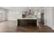 Spacious kitchen featuring a large island, modern appliances, ample cabinetry, and wood-look flooring at 22500 E Orchard Ln, Queen Creek, AZ 85142