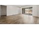Spacious living room with wood-look flooring and large sliding doors to the backyard at 22500 E Orchard Ln, Queen Creek, AZ 85142