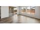 Bright living room with wood-look floors and views of the backyard through the windows at 22500 E Orchard Ln, Queen Creek, AZ 85142