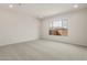Carpeted bedroom featuring a large window, offering plenty of natural light and a peaceful ambiance at 22536 E San Tan Blvd, Queen Creek, AZ 85142