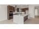 Well-equipped kitchen with stainless steel appliances, a spacious island, and stylish dark wood cabinets at 22536 E San Tan Blvd, Queen Creek, AZ 85142