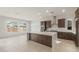 Modern kitchen features a large center island, stainless steel appliances, and an open layout to the living area at 22536 E San Tan Blvd, Queen Creek, AZ 85142
