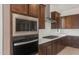Close-up of the sleek stainless steel appliances, dark cabinets, and stylish countertop in the kitchen at 22536 E San Tan Blvd, Queen Creek, AZ 85142