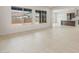 Spacious living room with large windows and tile floors, offering a glimpse into the modern kitchen at 22536 E San Tan Blvd, Queen Creek, AZ 85142
