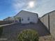 Gravel backyard with a view of the home's exterior and a block wall at 44394 W Palo Aliso Way, Maricopa, AZ 85138