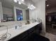 Modern bathroom with double vanity and walk-in closet at 44394 W Palo Aliso Way, Maricopa, AZ 85138