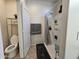 Small bathroom with toilet, shower, and shelving at 44394 W Palo Aliso Way, Maricopa, AZ 85138