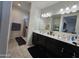 Primary bathroom with double vanity, large mirror, and shower at 44394 W Palo Aliso Way, Maricopa, AZ 85138