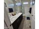 Bathroom with double sinks, a shower/tub combo, and tile flooring at 44394 W Palo Aliso Way, Maricopa, AZ 85138