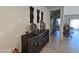 An entryway with decorative wall art and a dark brown console table at 44394 W Palo Aliso Way, Maricopa, AZ 85138