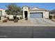 House exterior showcasing a two-car garage and landscaping at 44394 W Palo Aliso Way, Maricopa, AZ 85138