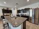 Spacious kitchen with granite island and stainless steel appliances at 44394 W Palo Aliso Way, Maricopa, AZ 85138