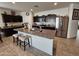 Kitchen with large island, stainless steel appliances, and dark cabinets at 44394 W Palo Aliso Way, Maricopa, AZ 85138
