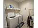 Laundry room with washer, dryer, and shelving at 44394 W Palo Aliso Way, Maricopa, AZ 85138