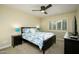 Well-lit bedroom with a full-size bed and dark wood frame at 18626 E Poco Rio Dr, Rio Verde, AZ 85263