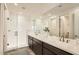 Elegant bathroom with dual sinks, sleek countertops, a large mirror, and a glass-enclosed shower for a spa-like experience at 2121 W Sonoran Desert Dr # 29, Phoenix, AZ 85085