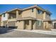 Modern townhome with a two-car garage, stone accents, and private balcony exuding curb appeal and contemporary design at 2121 W Sonoran Desert Dr # 29, Phoenix, AZ 85085