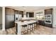 Spacious kitchen featuring dark cabinetry, a large center island with seating, and modern stainless steel appliances at 2121 W Sonoran Desert Dr # 29, Phoenix, AZ 85085
