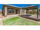 Exterior view of a covered patio and backyard featuring a gazebo with a wooden deck and landscaping at 303 W Mammoth Cave Dr, San Tan Valley, AZ 85140