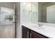 Well-lit bathroom featuring a modern vanity with white countertop and sleek fixtures plus view of the bedroom through the door at 303 W Mammoth Cave Dr, San Tan Valley, AZ 85140