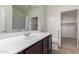 Bathroom featuring a large mirror, wood vanity, and shower-tub combination at 303 W Mammoth Cave Dr, San Tan Valley, AZ 85140