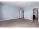 Light blue bedroom with two door ways and wood floors at 303 W Mammoth Cave Dr, San Tan Valley, AZ 85140