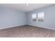 Light blue bedroom features wood floors and double windows at 303 W Mammoth Cave Dr, San Tan Valley, AZ 85140