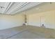 Large garage featuring concrete flooring and ample room for parking and storage at 303 W Mammoth Cave Dr, San Tan Valley, AZ 85140