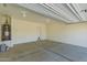 Spacious garage featuring concrete flooring and ample room for parking and storage at 303 W Mammoth Cave Dr, San Tan Valley, AZ 85140