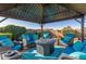 Covered patio with comfortable seating and fire pit at 303 W Mammoth Cave Dr, San Tan Valley, AZ 85140