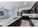 Bright kitchen showcases stainless steel appliances, granite countertops, and an island at 303 W Mammoth Cave Dr, San Tan Valley, AZ 85140