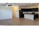 Modern kitchen with black cabinets, granite countertops, and stainless steel appliances at 303 W Mammoth Cave Dr, San Tan Valley, AZ 85140