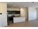 Bright kitchen with black cabinets, stainless steel appliances, and granite countertop island at 303 W Mammoth Cave Dr, San Tan Valley, AZ 85140