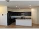 Stylish kitchen with black cabinets, granite countertops, and stainless steel appliances at 303 W Mammoth Cave Dr, San Tan Valley, AZ 85140