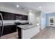 Charming kitchen boasts granite countertops, stainless steel appliances, and dark wood cabinets at 303 W Mammoth Cave Dr, San Tan Valley, AZ 85140