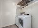 Efficient laundry room featuring modern washer and dryer, plus wire rack shelving at 303 W Mammoth Cave Dr, San Tan Valley, AZ 85140