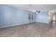 Spacious living room with wood-look floors, neutral paint, and large windows for ample natural light at 303 W Mammoth Cave Dr, San Tan Valley, AZ 85140