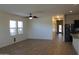 Open-concept living space with wood-look floors, a ceiling fan, and kitchen view at 303 W Mammoth Cave Dr, San Tan Valley, AZ 85140