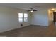 Bright living room with wood-look floors, large windows, and neutral paint at 303 W Mammoth Cave Dr, San Tan Valley, AZ 85140