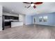 Open-concept space featuring wood-look floors, a kitchen with an island, and ample natural light at 303 W Mammoth Cave Dr, San Tan Valley, AZ 85140