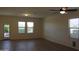 Bright living room with wood-look floors, back door, and large windows at 303 W Mammoth Cave Dr, San Tan Valley, AZ 85140