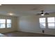 Open living room with wood-look floors, recessed lighting, and large windows at 303 W Mammoth Cave Dr, San Tan Valley, AZ 85140