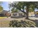 Classic light-yellow home with mature shade tree and yard at 315 W Roma Ave, Phoenix, AZ 85013