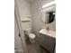 Powder bathroom features a modern vanity with round mirror and tiled floors at 418 N Sirrine --, Mesa, AZ 85201