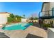 Backyard pool with travertine surround, adjacent to a second story deck with black iron railings at 6174 E Janice Way, Scottsdale, AZ 85254