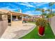 Spacious backyard with patio, artificial turf, and large potted plant at 6713 E Paradise Ln, Scottsdale, AZ 85254